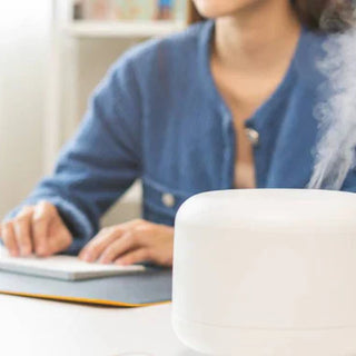 Woman enjoying aromatherapy at work.