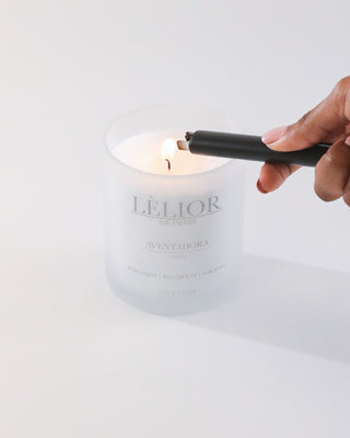 Luxury candle 10oz Aventadora scent white backround hand lighting the candle 